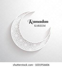 White ornamental moon with shadow and the black inscription Ramadan Kareem on a light background.