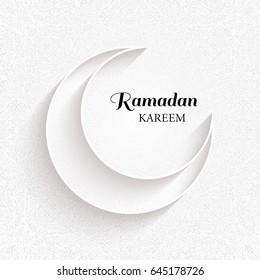 White ornamental moon with shadow and the black inscription Ramadan Kareem on a light background.