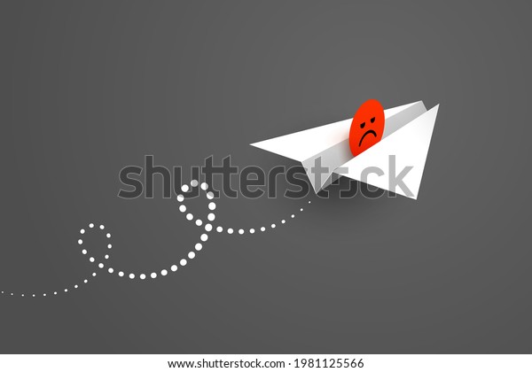 White paper\
airplane and red unhappy face icon over dark background. Concept of\
bad news, bad mood, expression of dissatisfaction, negative\
feedback and user\
experience