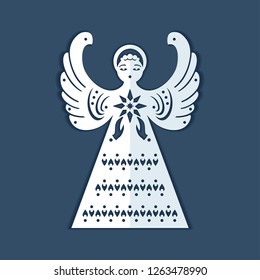 White paper angel with a christmas star on a dark blue background. Beautiful decor angel is form for carving. Christmas angel is form for cutting. Symmetrical static silhouette can be used for differe