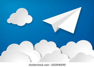 white paper aplane with clouds on a blue air background.  Blue sky travel background.