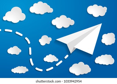 white paper aplane with clouds on a blue air background.  Blue sky travel background.