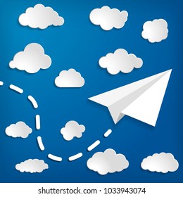white paper aplane with clouds on a blue air background.  Blue sky travel background.