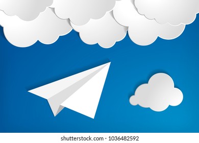 white paper aplane with clouds on a blue air background.  Blue sky travel background