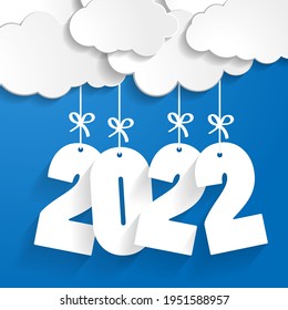 white paper clouds with numbers 2022 of coming year hanging on strings with bows on blue background