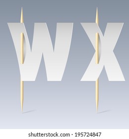 White paper cut font on toothpicks on grey background. W and X letters