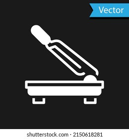 White Paper cutter icon isolated on black background. Vector