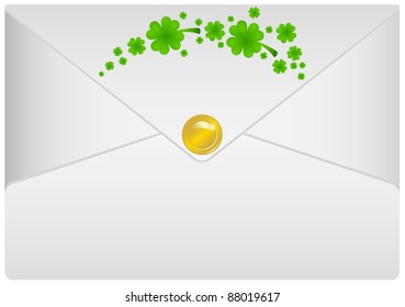 White paper envelope placed in it a foliage clover and gold coin