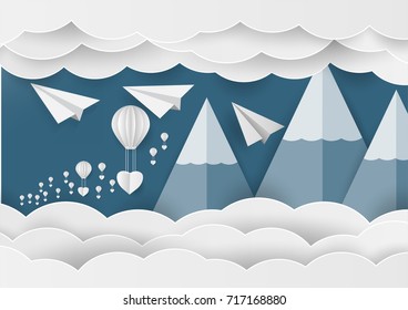 White paper heart shape and balloon in the sky with mountain and cloud. Paper art idea