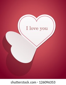 White paper heart Valentines day card on red background