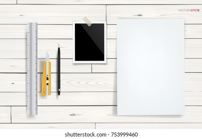 White paper sheet and blank photo frame on white wooden background. Vector illustration.