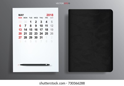 White paper sheet with May 2018 calendar and black notebook on gray gradient background. Vector illustration.