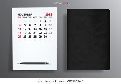 White paper sheet with November 2018 calendar and black notebook on gray gradient background. Vector illustration.