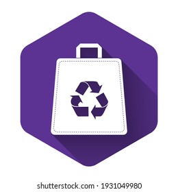 White Paper shopping bag with recycle icon isolated with long shadow. Bag with recycling symbol. Purple hexagon button. Vector Illustration