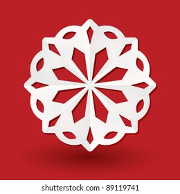 White paper snowflake on a red background