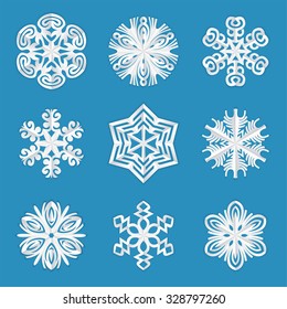 White paper snowflakes with subtle folds on a blue background. Vector illustration of nine origami snowflakes cut out of paper