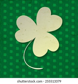 White paper three leaf clover on green background with clover pattern and old paper texture.