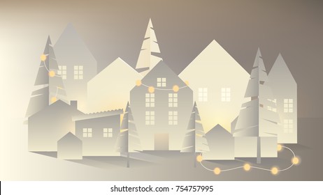 White paper village decorated with glowing Christmas lights