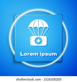 White Parachute with first aid kit icon isolated on blue background. Medical insurance. Blue square button. Vector Illustration