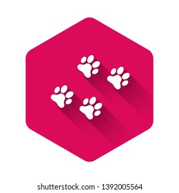 White Paw print icon isolated with long shadow. Dog or cat paw print. Animal track. Pink hexagon button. Vector Illustration