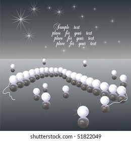 White pearls on a black table.