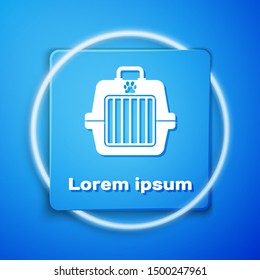 White Pet carry case icon isolated on blue background. Carrier for animals, dog and cat. Container for animals. Animal transport box. Blue square button. Vector Illustration