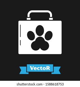 White Pet first aid kit icon isolated on black background. Dog or cat paw print. Clinic box.  Vector Illustration