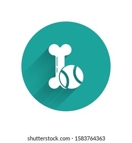 White Pet toys bone rubber and ball icon isolated with long shadow. Green circle button. Vector Illustration