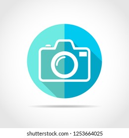 White photo camera in flat design with long shadow. Vector illustration. Simple photo camera icon on blue round button.