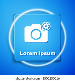 White Photo camera and gear icon isolated on blue background. Adjusting app, service concept, setting options, maintenance, repair, fixing. Blue square button. Vector Illustration