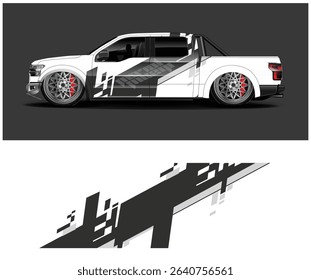 White pickup truck with custom black and gray geometric vinyl wrap design. Side profile view.