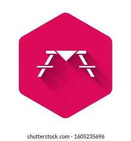White Picnic table with benches on either side of the table icon isolated with long shadow. Pink hexagon button. Vector Illustration