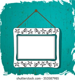 White picture frame with silhouettes of fish hangs on the wall blue.