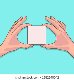 White piece of paper in the female hands on blue background. Blank sheet of paper