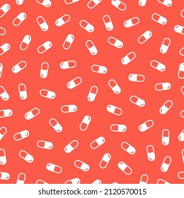 Las píldoras blancas son un patrón impecable con fondo rojo.