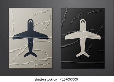 White Plane icon isolated on crumpled paper background. Flying airplane icon. Airliner sign. Paper art style. Vector Illustration