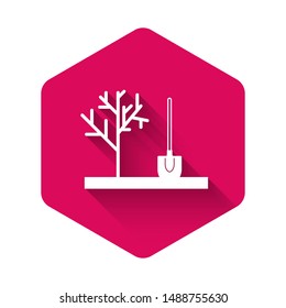 White Planting a tree in the ground icon isolated with long shadow. Gardening, agriculture, caring for environment. Pink hexagon button. Vector Illustration