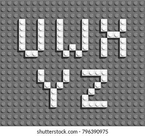 White plastic letters from building lego bricks. Gray lego background
