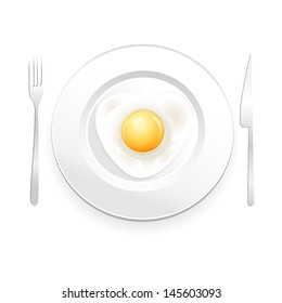 White plate with fried eggs on a white background with a knife and fork