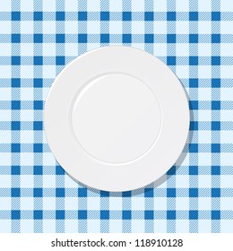 White plate on blue tablecloth