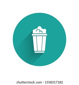 White Popcorn in cardboard box icon isolated with long shadow. Popcorn bucket box. Green circle button. Vector Illustration