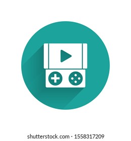 White Portable video game console icon isolated with long shadow. Gamepad sign. Gaming concept. Green circle button. Vector Illustration