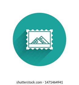 White Postal stamp and Egypt pyramids icon isolated with long shadow. Green circle button. Vector Illustration