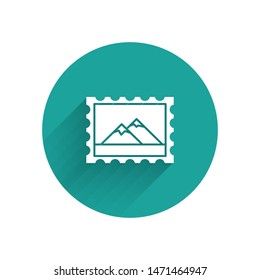 White Postal stamp and Mountains icon isolated with long shadow. Green circle button. Vector Illustration