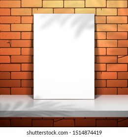 A white poster stands near the red brick wall on the shelf. Mockup for design with palm tree shadow