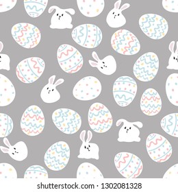 White rabbit sitting among Easter eggs. On a gray background. Seamless pattern