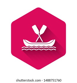 White Rafting boat icon isolated with long shadow. Kayak with paddles. Water sports, extreme sports, holiday, vacation, team building. Pink hexagon button. Vector Illustration