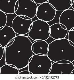 white random doodle circles and dots on black. seamless vector pattern