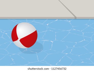 White and red beach ball in a pool on a summer day.