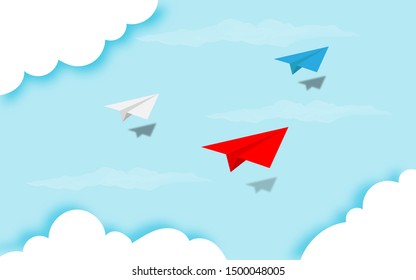 White, red and blue paper airplanes flying together on blue sky and cloud background. Creative concept idea of  business success and leadership in paper craft art style design .Vector illustration
